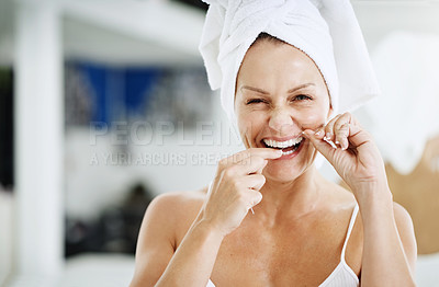 Buy stock photo Cropped shot of a mature woman flossing her teeth