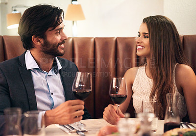 Buy stock photo Restaurant, couple and valentines day date with wine glass, love and happy communication to celebrate. Young man and woman together for fine dining, drinks and romantic dinner for holiday celebration