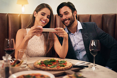 Buy stock photo Couple, restaurant and phone for photo of food, pizza or romantic date night meal for valentines day. Social media, picture and influencer man with woman on smartphone for blog, review or eating post