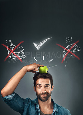Buy stock photo Studio portrait of a handsome young man standing with an apple on his head against an illustration of his choices against a grey background