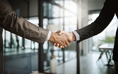 Buy stock photo Professional corporate males giving handshake in modern office after agreeing on business deal closeup. Two confident, formal and executive men coming to an agreement together at the end of a meeting