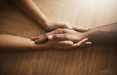 Buy stock photo Love, support and care with people holding hands at a table, talking, bonding and showing affection. Couple having a discussion about relationship. Woman helping husband with his mental health