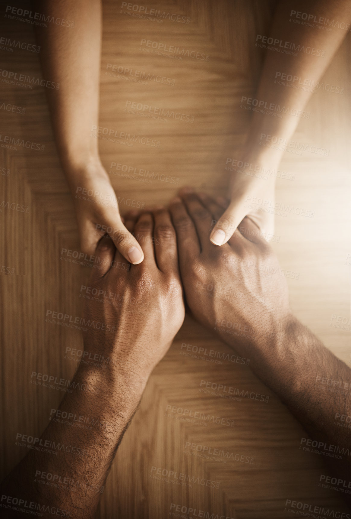 Buy stock photo Holding hands, love and support with people at wooden table from above for comfort or empathy. Anxiety, depression and trust with friends in home together for help in crisis of grief, loss or pain