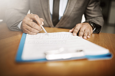 Buy stock photo Cropped shot of an unrecognizable businessperson signing papers inside of the office during the day