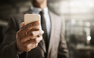 Buy stock photo Businessman browsing on his phone online to look at his social media in the office, close up. Corporate professional in a suit reading a sms message. Male executive checking his news feed
