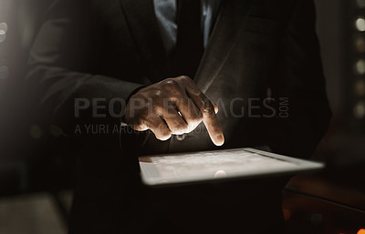 Buy stock photo Cropped shot of an unrecognizable businessperson browsing on a digital tablet inside of the office during the day