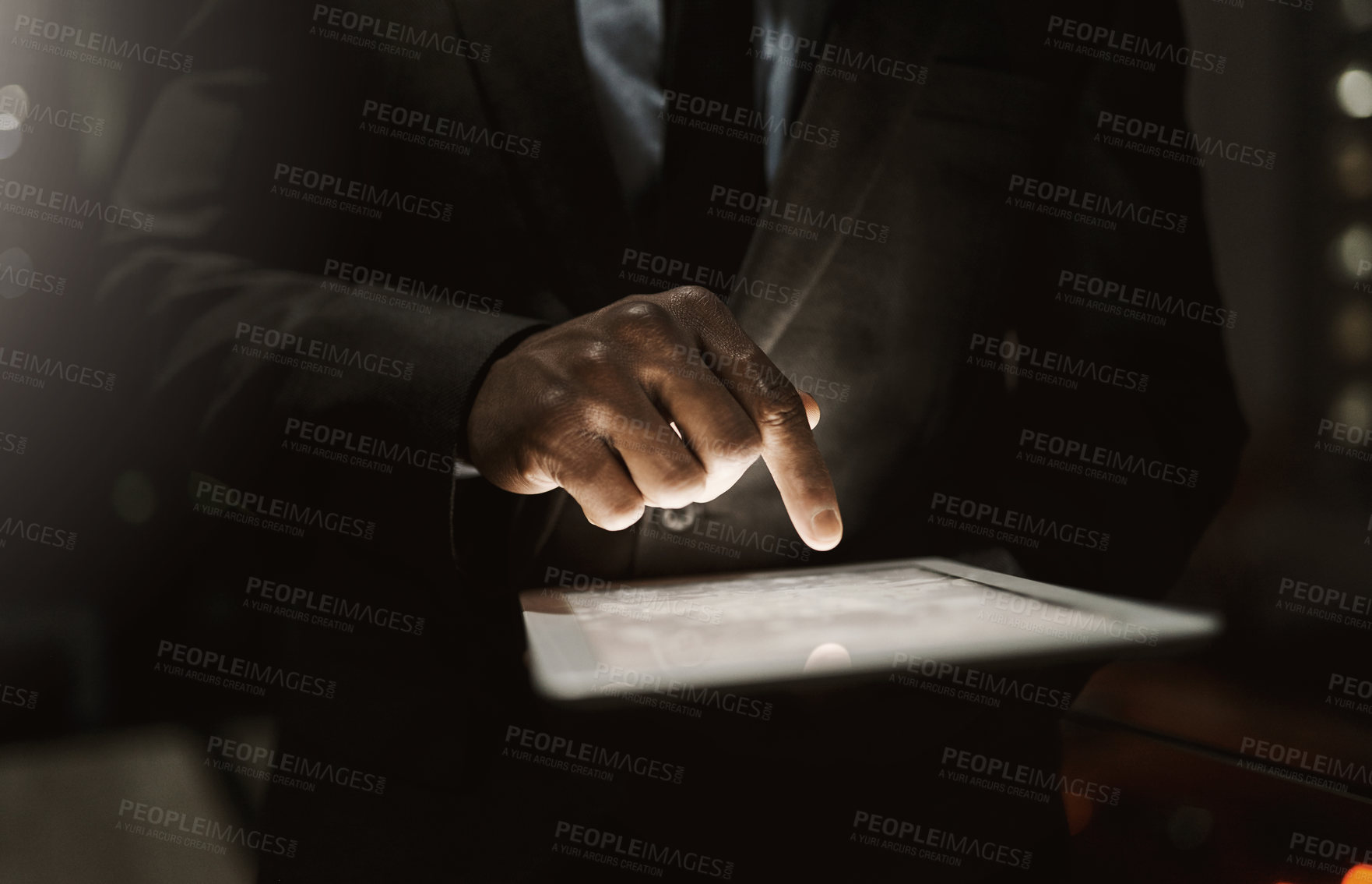 Buy stock photo Cropped shot of an unrecognizable businessperson browsing on a digital tablet inside of the office during the day