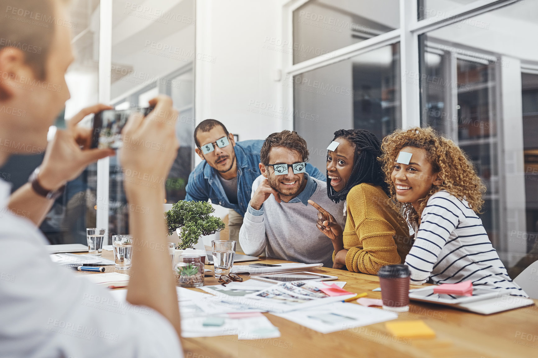 Buy stock photo Silly, notes and eyes of business people in meeting with staff picture for social media in office. Employee, smile and creative employees with comedy, team building and fun in boardroom with photo