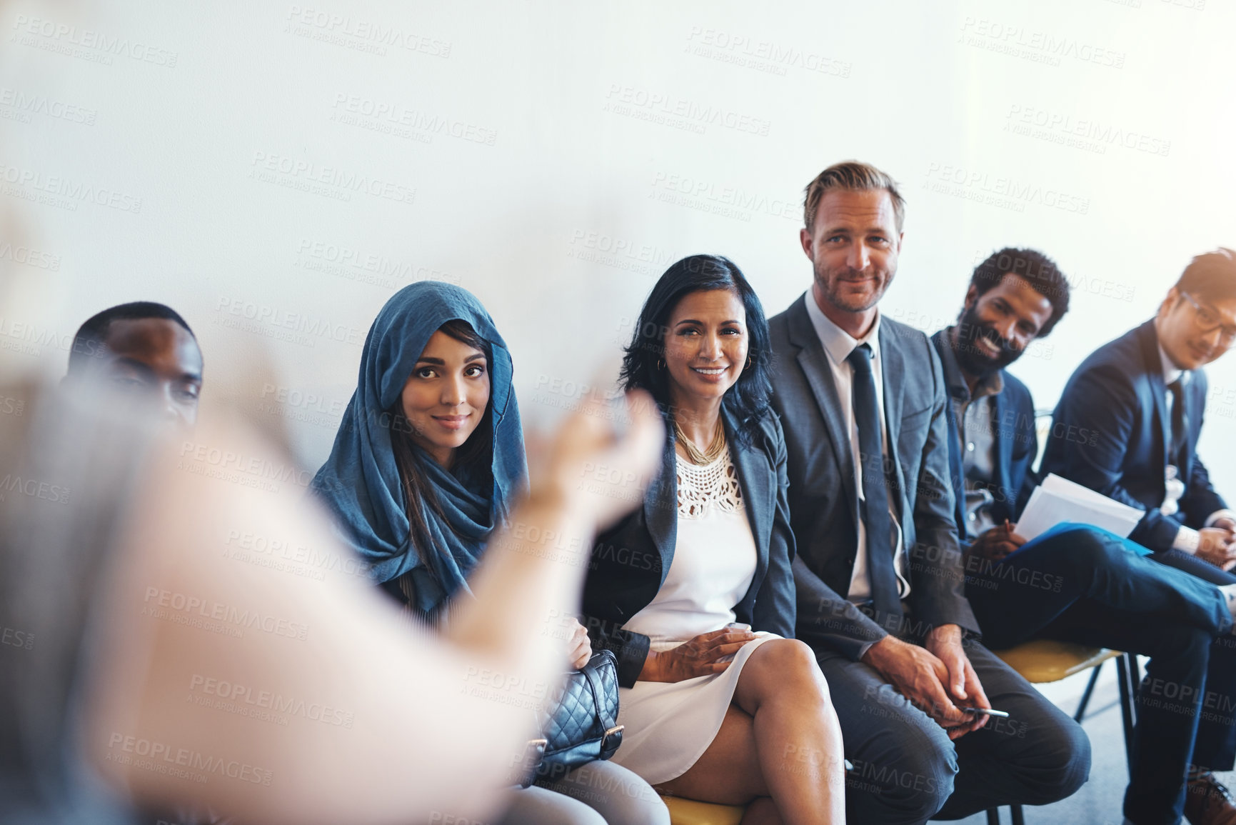 Buy stock photo Shot of a group of confident businesspeople waiting in line for their interviews inside of a office during the day