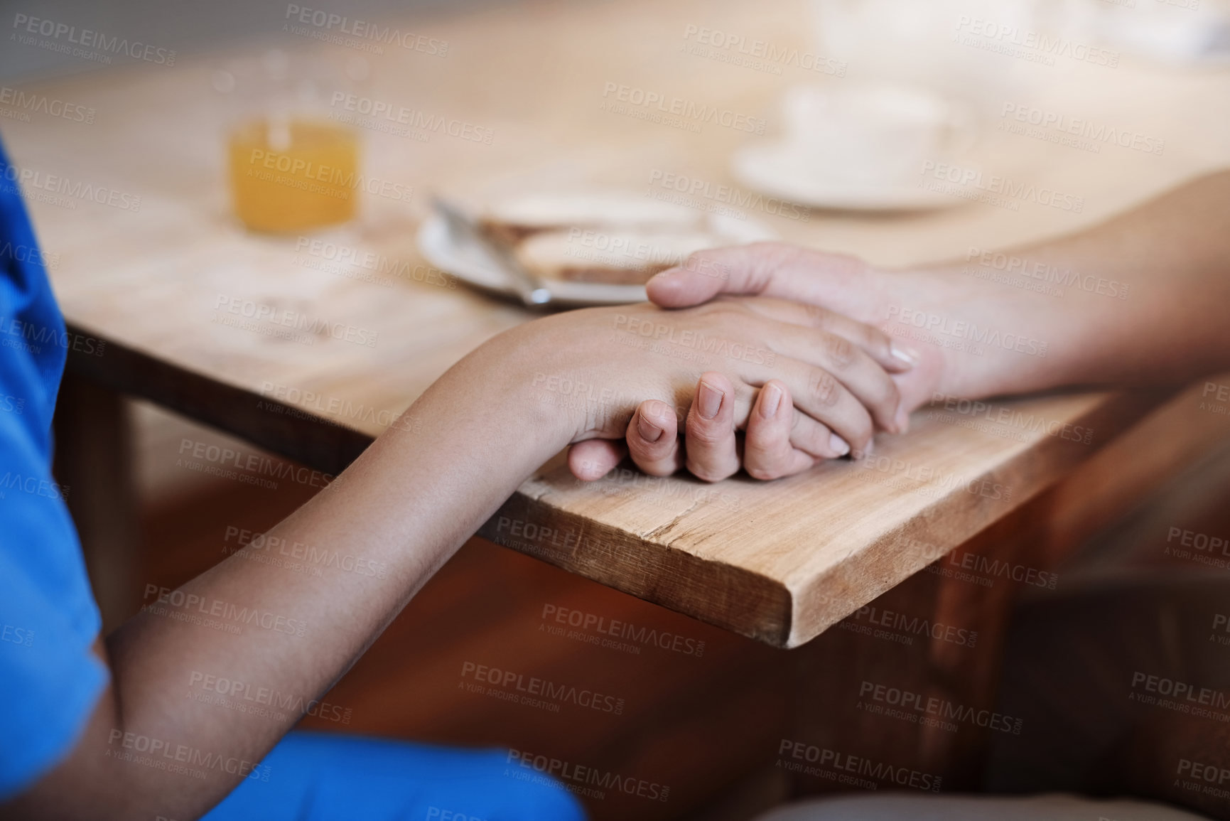 Buy stock photo People, holding hands and empathy in nursing home for help, support or hope in living room. Caregiver, woman or senior care at wooden table for grief counselling, trust or mental health in retirement