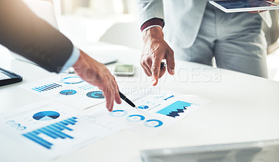 Buy stock photo Cropped shot of two unrecognizable businessmen discussing paperwork at the table in the boardroom