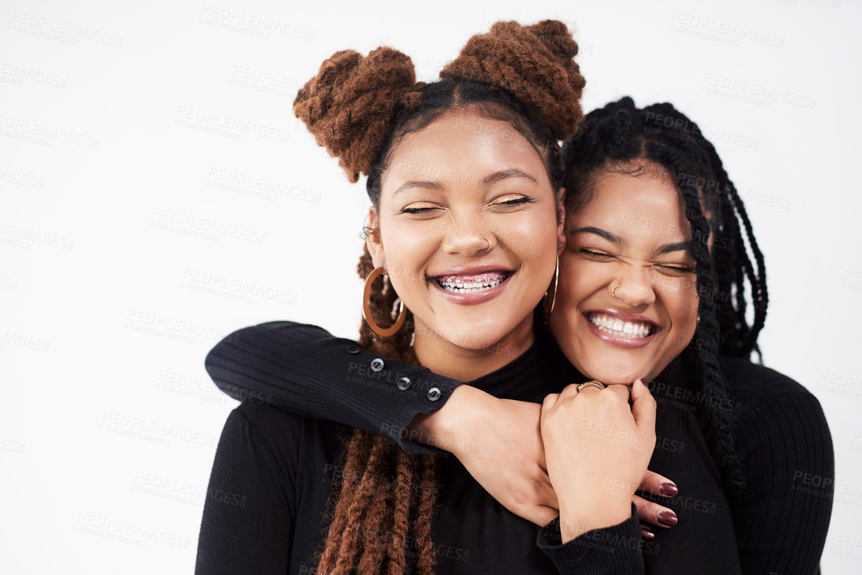 Buy stock photo Studio shot of two beautiful young women posing against a grey background