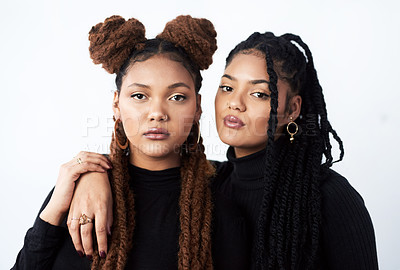 Buy stock photo Studio shot of two beautiful young women posing against a grey background