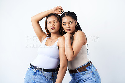 Buy stock photo Studio shot of two beautiful young women posing against a grey background