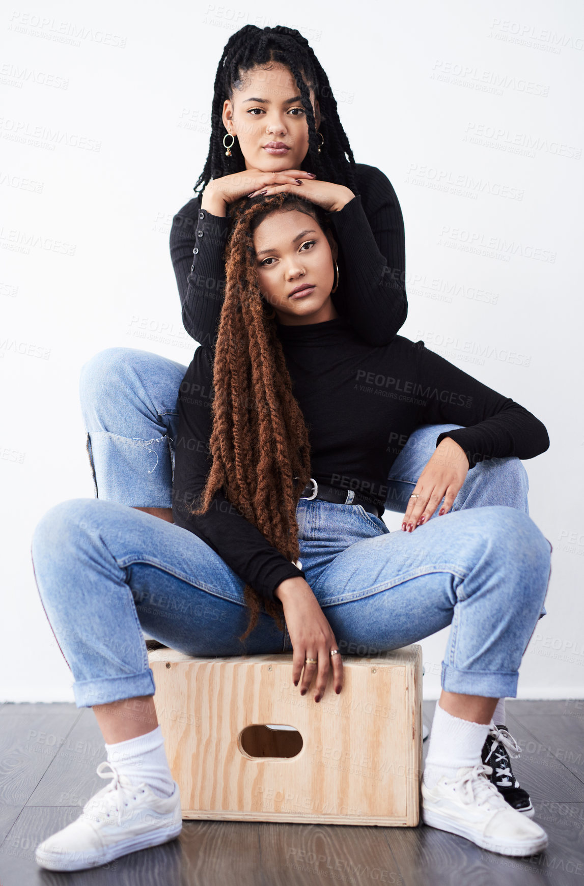 Buy stock photo Lesbian couple, portrait and fashion in studio with pride for style inspiration, blue jeans and support. Serious, lgbt and black people for clothes with women, relationship and braids with confidence