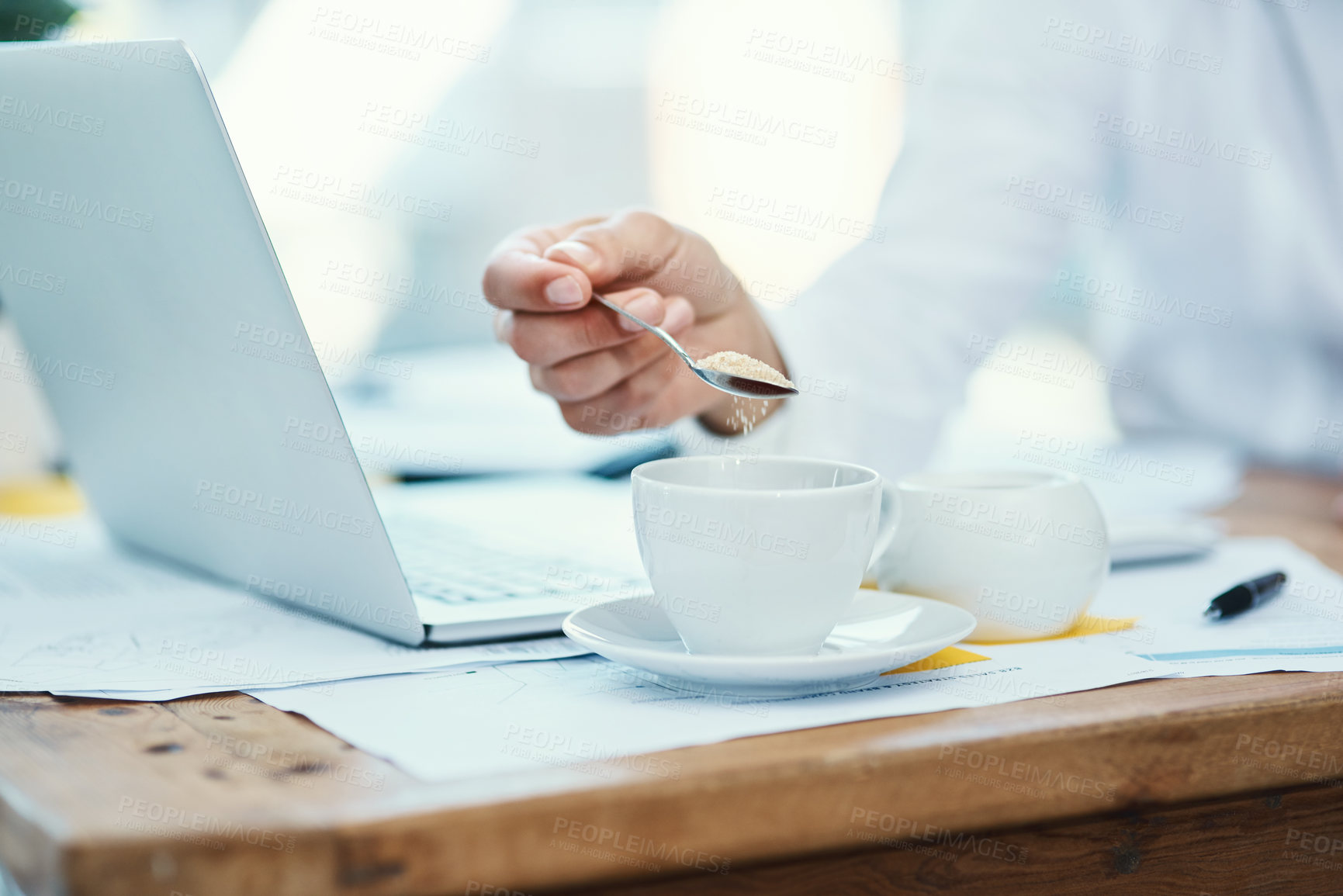 Buy stock photo Tea, sugar and hand of person in office with tech, preparation and hot drink in business. Finance employee, coffee or sweetener at desk for refreshment, caffeine addiction or morning on new day