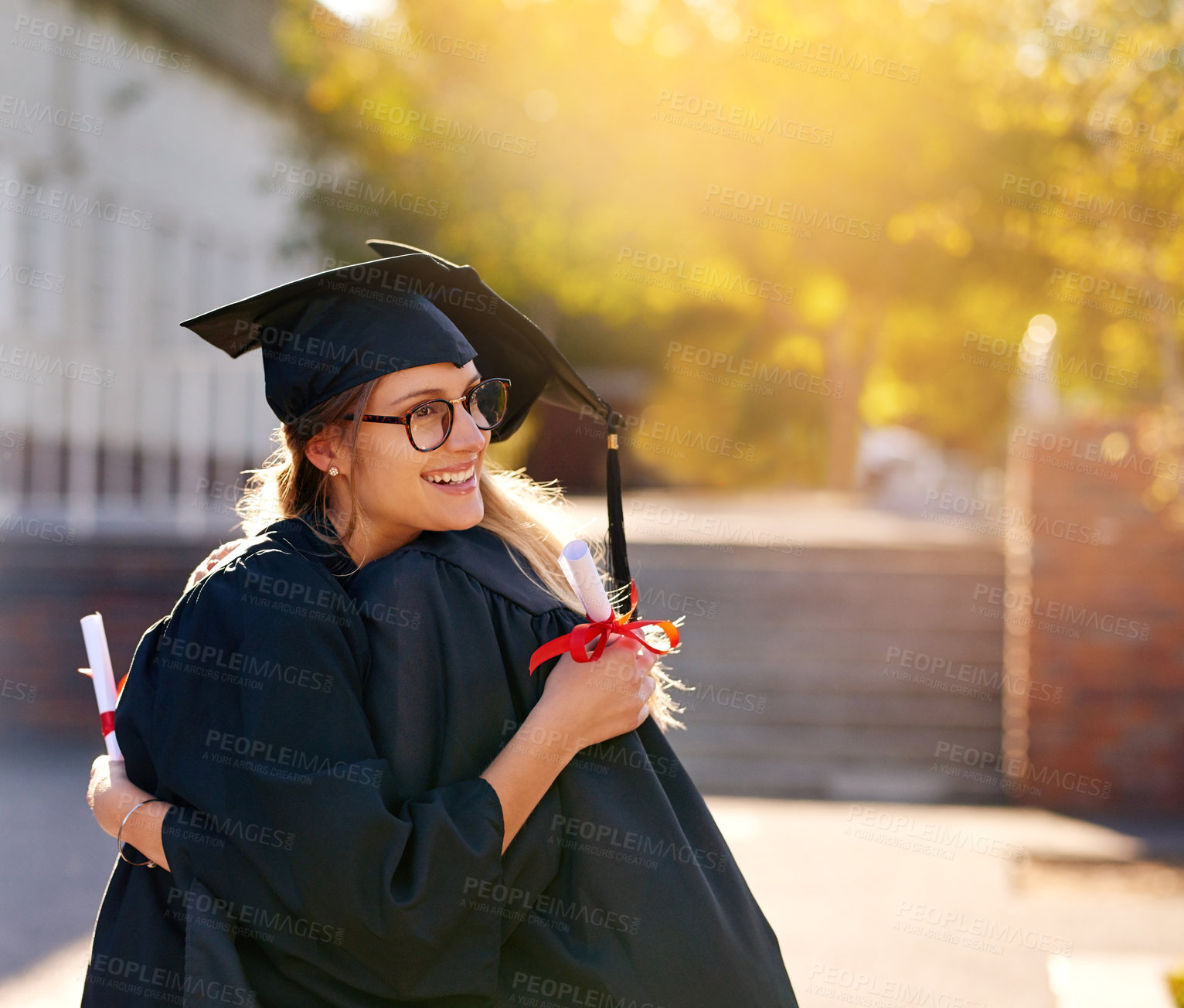 Buy stock photo Women, students and hug at graduation as college or university friends with achievement. Happy people outdoor to celebrate education goals, certificate of success or future at school event with pride