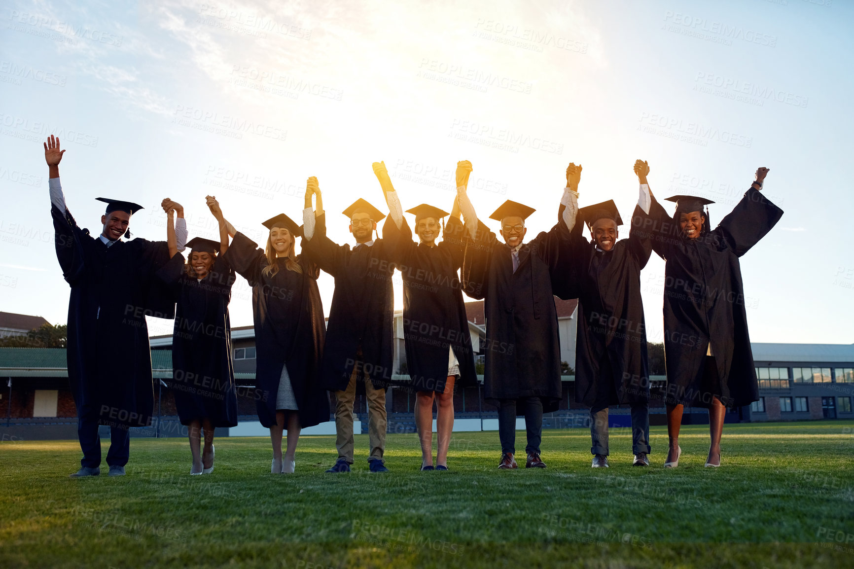 Buy stock photo College, graduation and portrait of people with celebration for education, achievement and success. Happy, students and friends holding hands in row at field for qualification, knowledge and learning