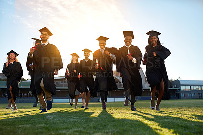 Buy stock photo Portrait of a group of university students celebrating their graduation