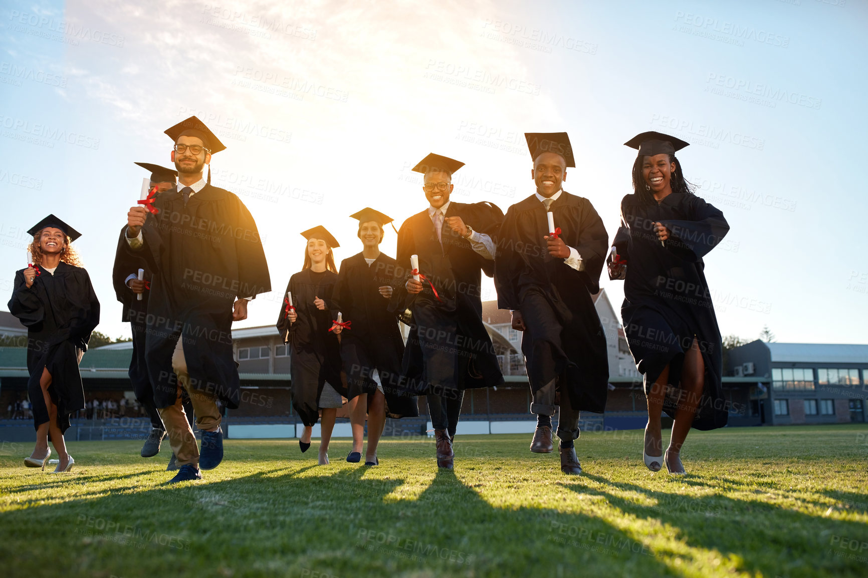 Buy stock photo Graduation, group run and campus lawn with college success, student celebration and diploma event at university. Friends, outdoor and academy achievement with ceremony, people and freedom together