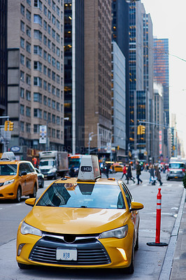Buy stock photo Shot of a taxi cab driving through the city