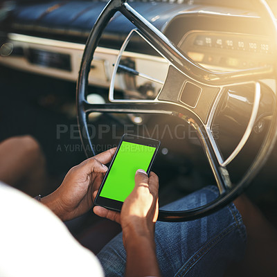 Buy stock photo Cropped shot of an unrecognizable man using his cellphone while sitting in his car