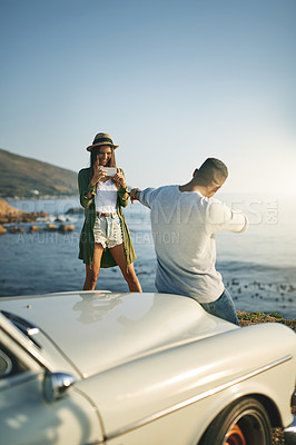 Buy stock photo Photograph, smile and travel with couple at ocean together for holiday, road trip or vacation in nature. Bonding, love or social media with man and woman outdoor for anniversary, honeymoon or romance