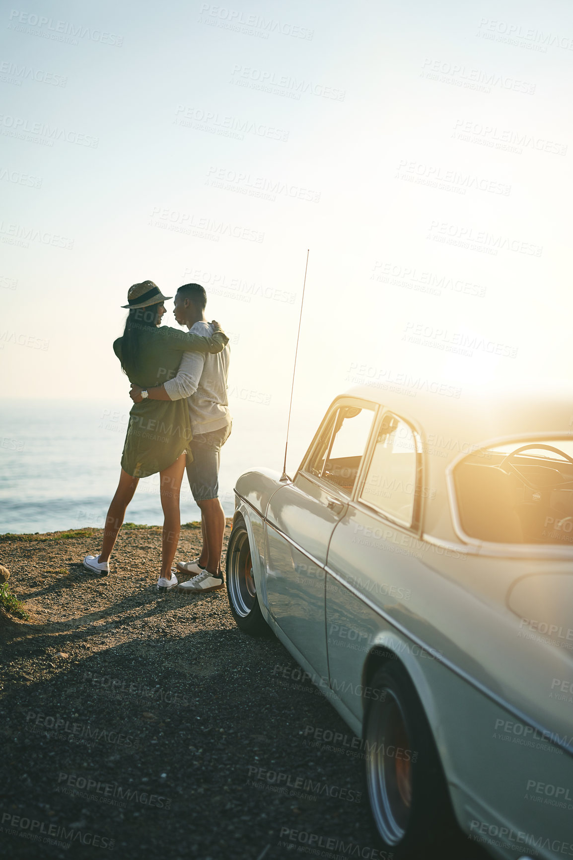 Buy stock photo Shot of a young couple making a stop at the beach while out on a roadtrip