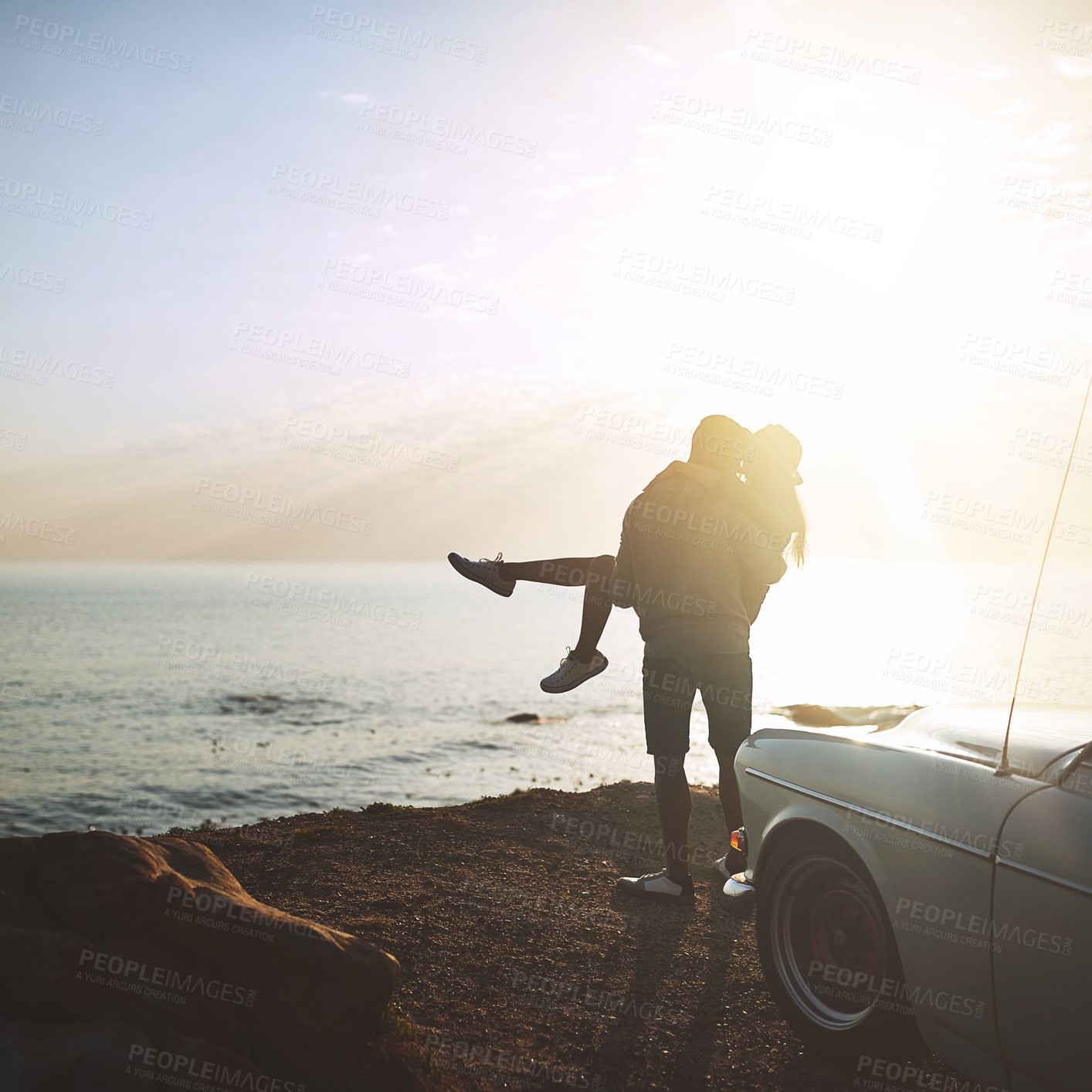 Buy stock photo Back, carry and travel with couple at ocean together for holiday, road trip or vacation with sunshine. Adventure, bonding or lifting with man and woman outdoor for anniversary, honeymoon or love