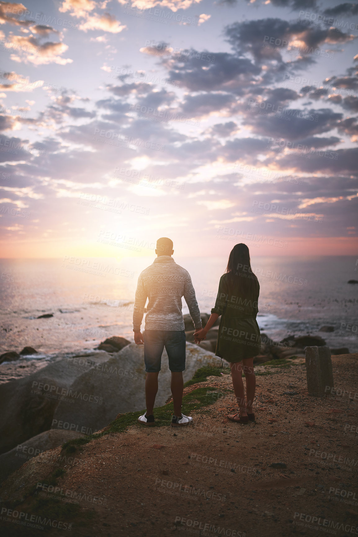 Buy stock photo Love, sunset and holding hands with couple at beach for travel destination, summer and honeymoon vacation. Relax, tropical and adventure with man and woman for holiday, bonding and romance together
