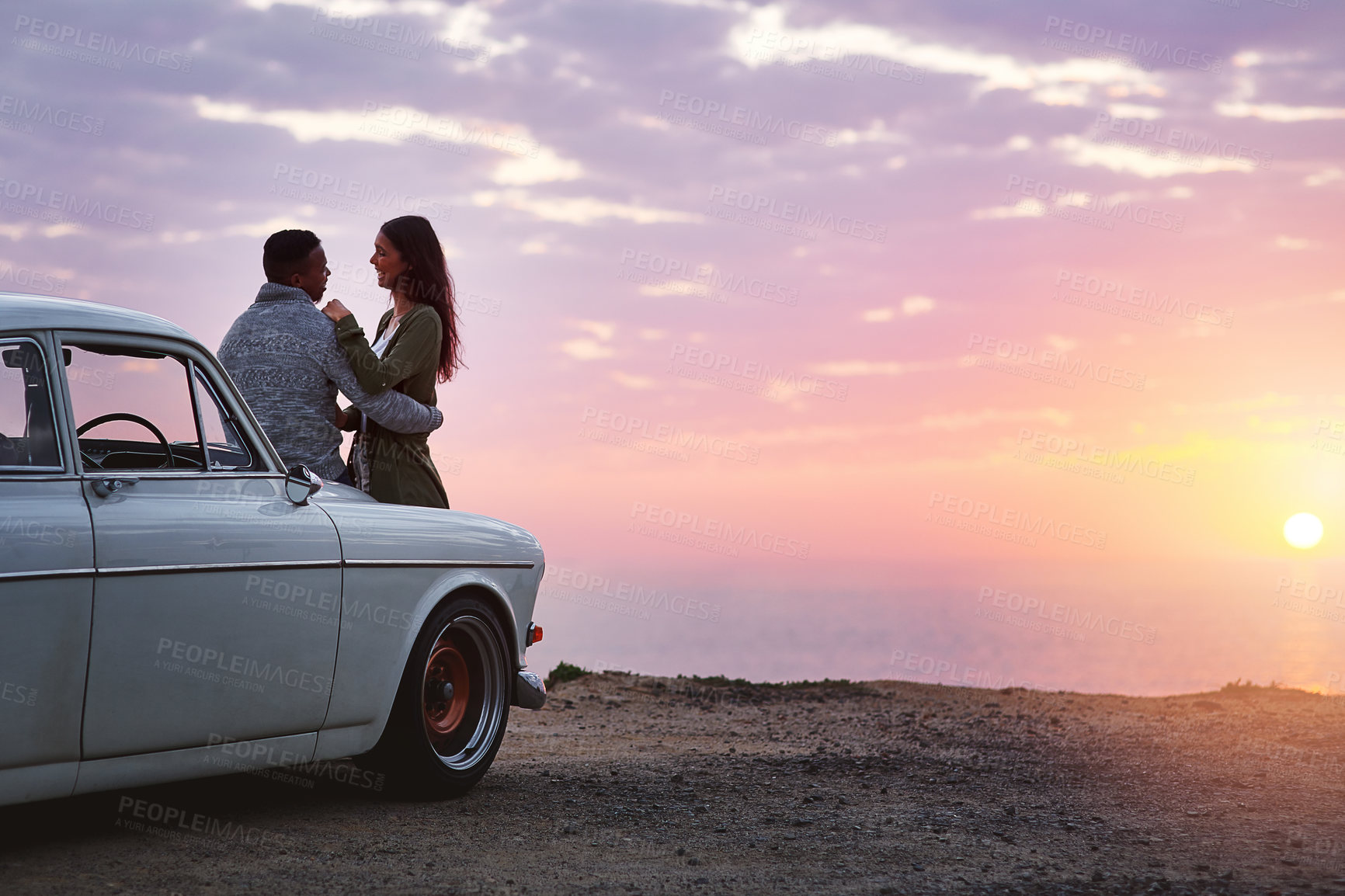 Buy stock photo Couple, sunset and road trip by ocean for love, embrace and holiday on car with fun adventure. People, hug and connection by beach for travel, relationship and vacation with explore, bonding or relax