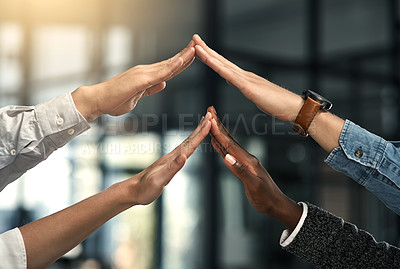 Buy stock photo Cropped shot of a group of businesspeople touching each others hands