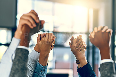 Buy stock photo Cropped shot of a group of businesspeople holding hands in solidarity