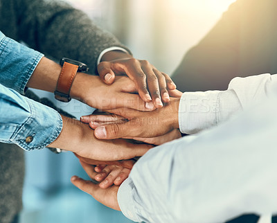 Buy stock photo Cropped shot of a group of businesspeople joining their hands in solidarity