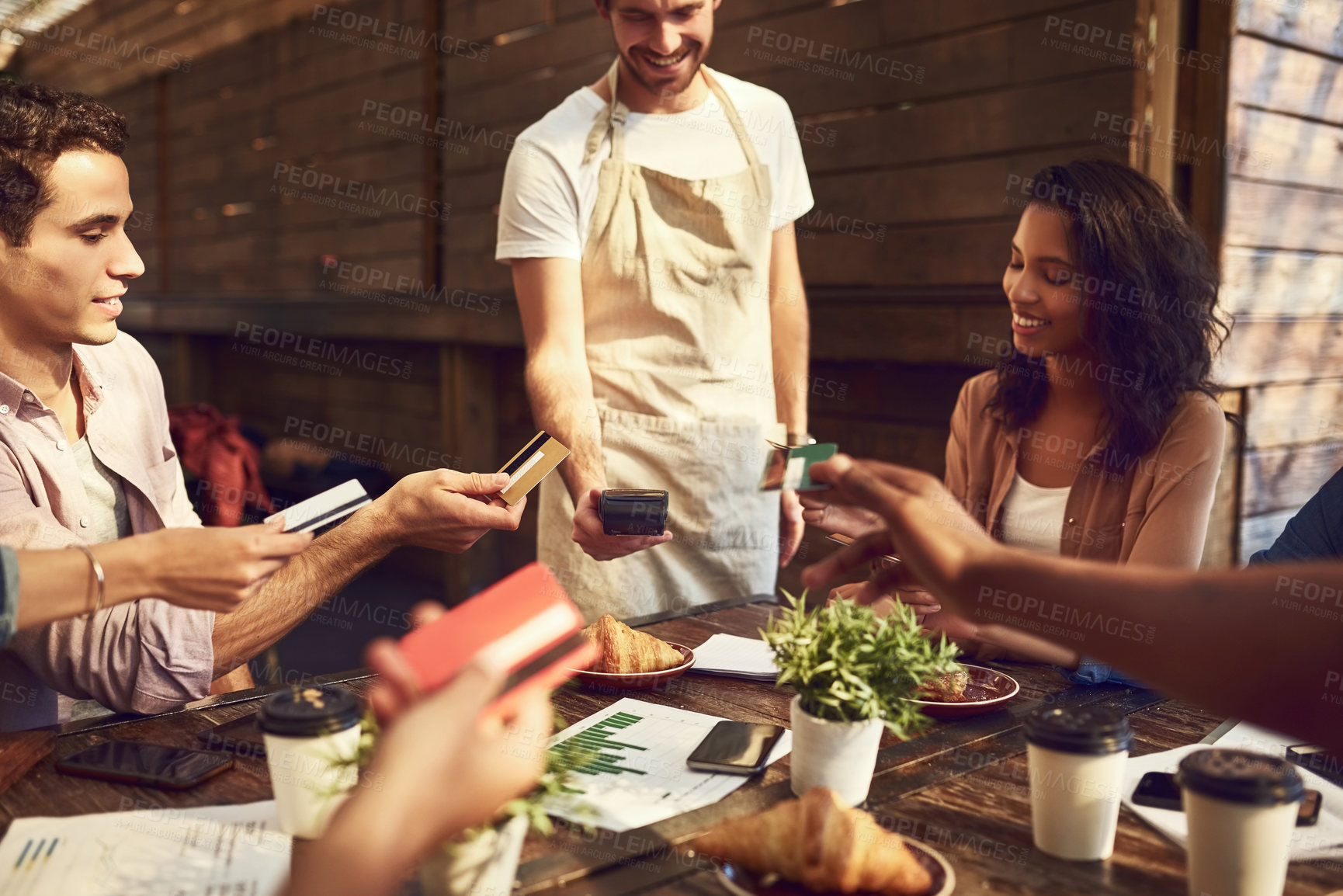 Buy stock photo Group, credit card and friends at coffee shop for payment of food transaction on pos machine. Waiter, hands or debit at cafe for finance service, banking or happy business people share to split bill