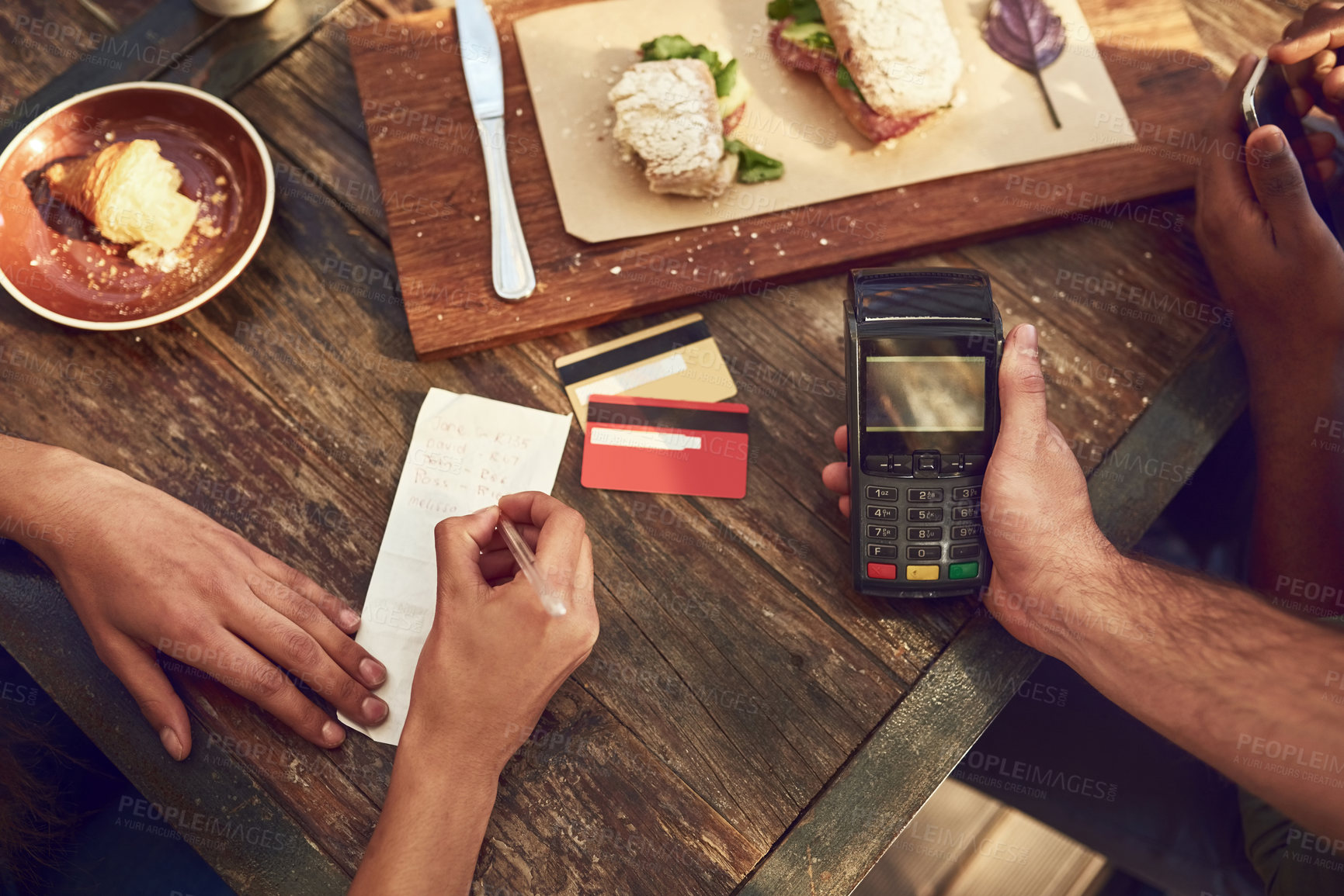 Buy stock photo Hands, food and restaurant for payment with credit card, machine and bill for lunch or meal in cafe. People, service and writing on check as customer in cashless transaction in sale for ecommerce