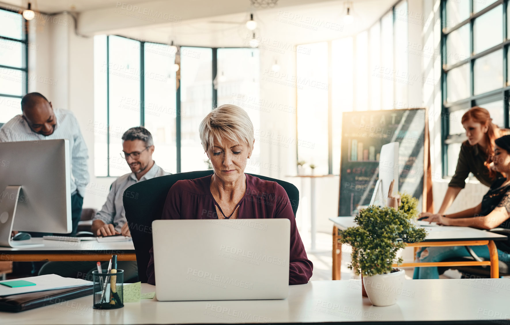 Buy stock photo Mature woman, typing and laptop in office for creative journalism, research and coworking of copywriting project. Female person, digital and reading feedback, editing article and publishing agency