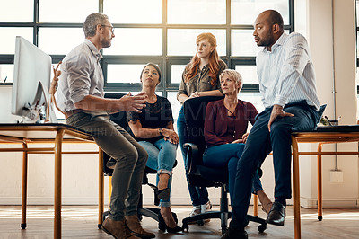 Buy stock photo Shot of a group of businesspeople having a discussion in a modern office