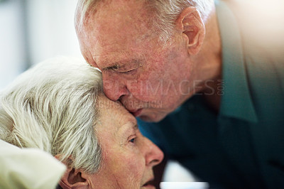 Buy stock photo Senior, kiss and couple in hospital for healthcare, visiting sick patient and hope for recovery. Clinic, elderly man and woman kissing on forehead with love, care and empathy, kindness and comfort.