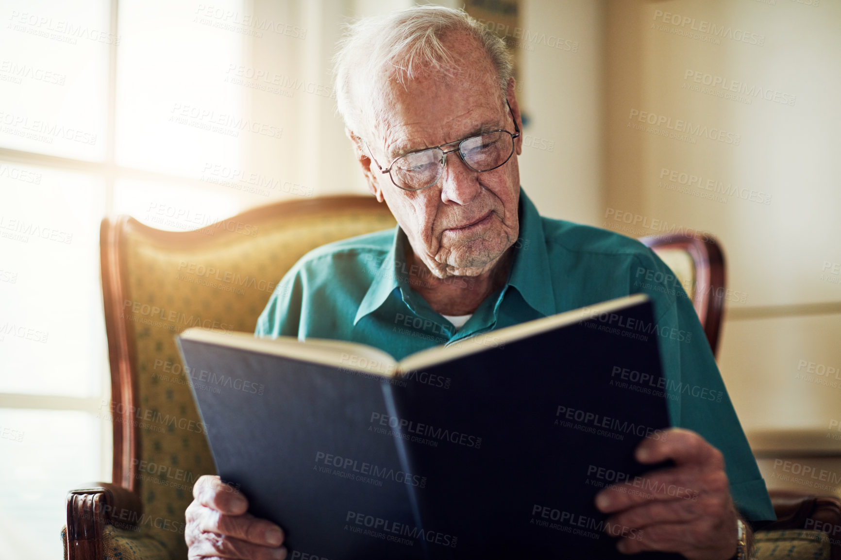 Buy stock photo Elderly man, peace and reading book in home, literature and language for learning in retirement. Old person, fiction and textbook for knowledge to relax on sofa, glasses and studying information