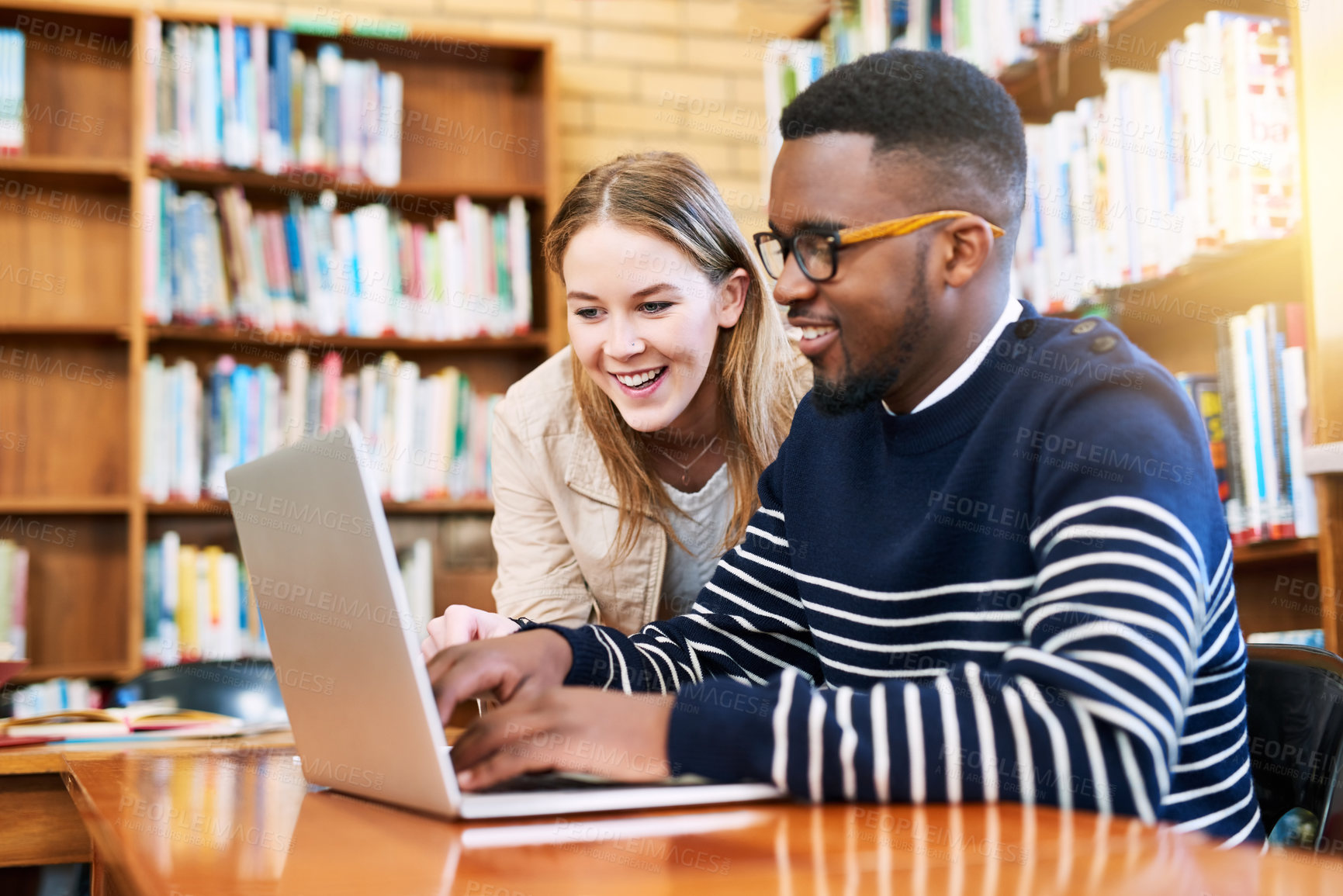 Buy stock photo Woman, student and laptop in library as friends or research, education and exam preparation in university. Man, studying and technology with smile for knowledge, social media and learning on internet