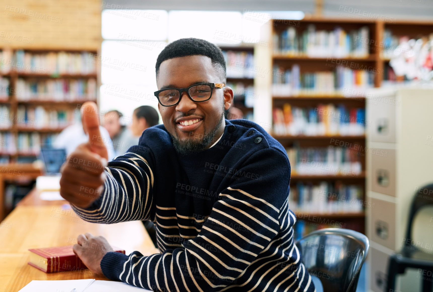 Buy stock photo Black man, student and happy with thumbs up, library and sign for choice, review and learning at campus. Person, smile and excited to study with icon, emoji and agreement for scholarship in Nigeria