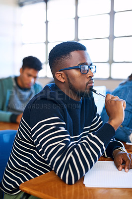 Buy stock photo Student, idea and black man in college classroom for education, test or exam. Thinking, university and study in lecture for problem solving, solution or brainstorming for learning knowledge at school