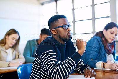 Buy stock photo Cropped shot of a university student sitting in class