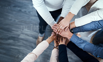 Buy stock photo High angle shot of a group of unrecognizable businesspeople putting their hands together in a huddle