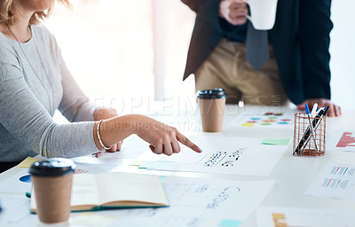 Buy stock photo Cropped shot of an unrecognizable businesswoman pointing at some paperwork during a meeting in an office
