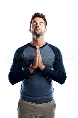 Buy stock photo Studio shot of a handsome young man praying against a white background