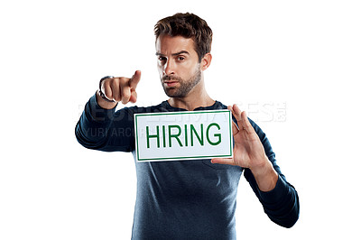 Buy stock photo Studio portrait of a handsome young man holding a hiring sign against a white background