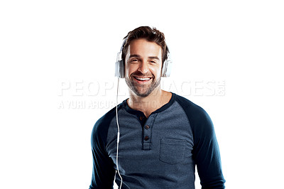Buy stock photo Studio portrait of a handsome young man using headphones against a white background