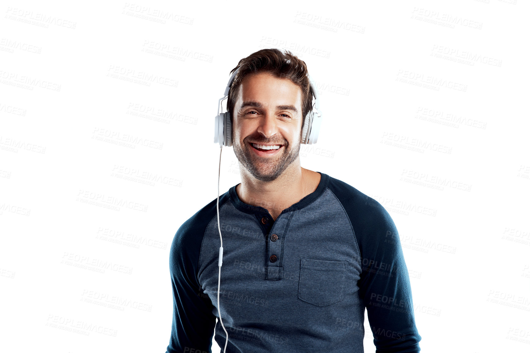 Buy stock photo Studio portrait of a handsome young man using headphones against a white background